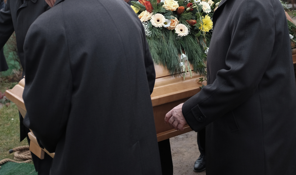 Pallbearers,Carry,A,Coffin,Decorated,With,Flowers